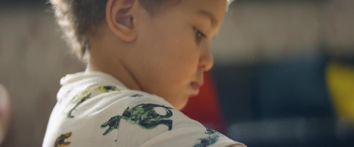 A toddler boy standing indoors
