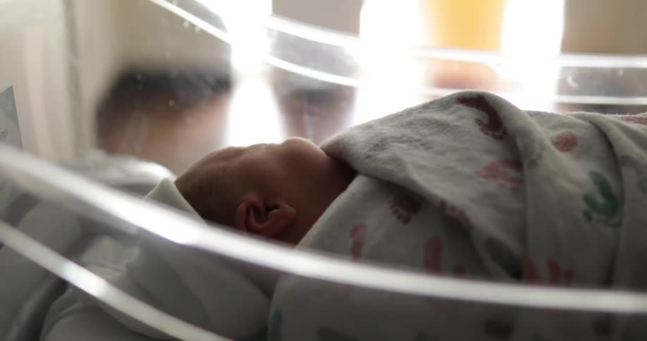 A baby that is laying in a nursery