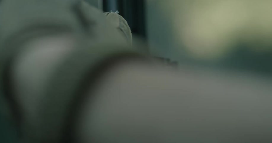 A person with gloves holding a rifle