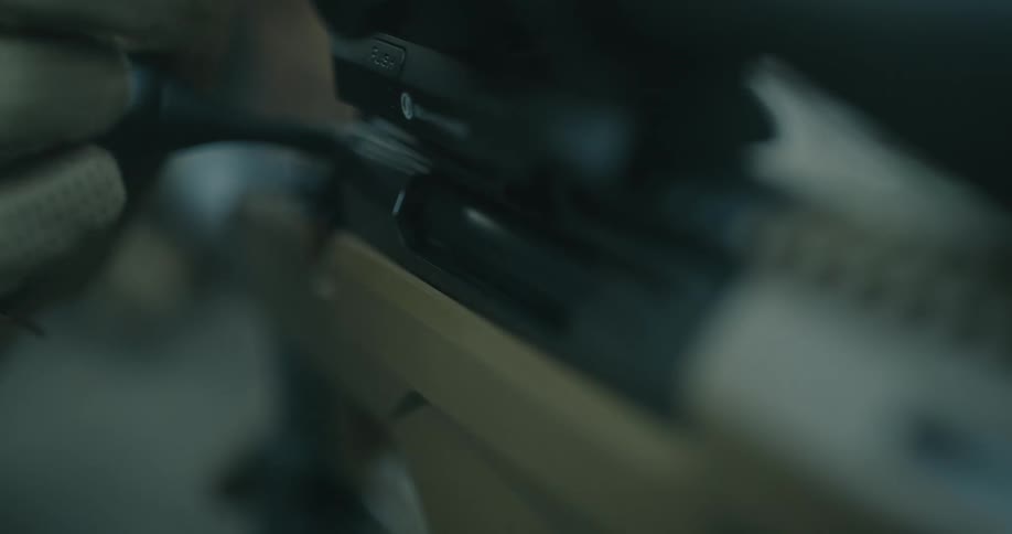 A person loading a gun