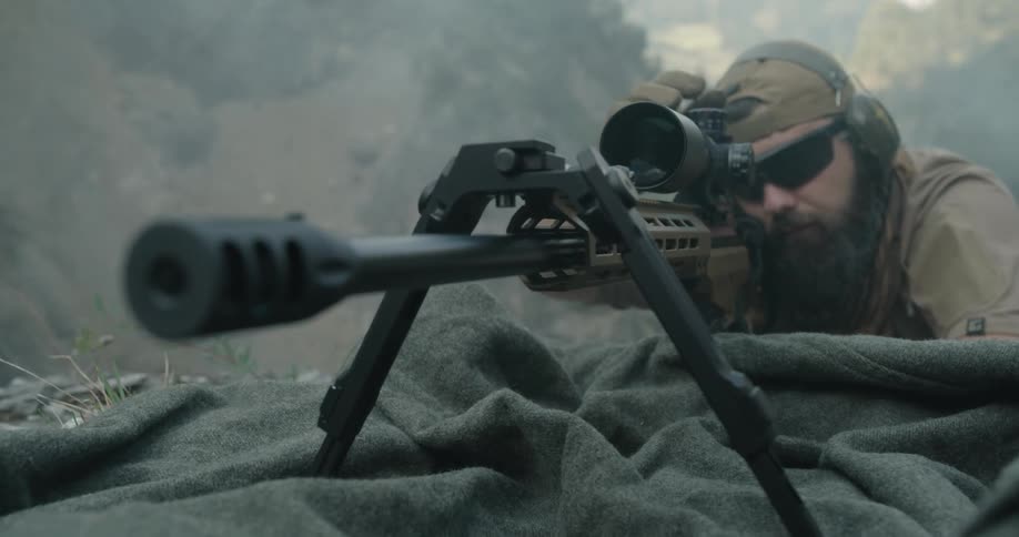 A soldier staring through the scope of a sniper rifle