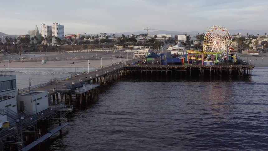 An aerial view of a pier with amusement park rides on it