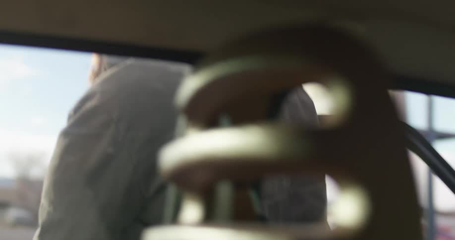 A woman gets out of her vehicle and shuts the door