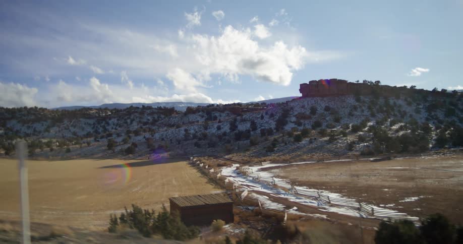 Snow patches on the fields and hills of the countryside at morning