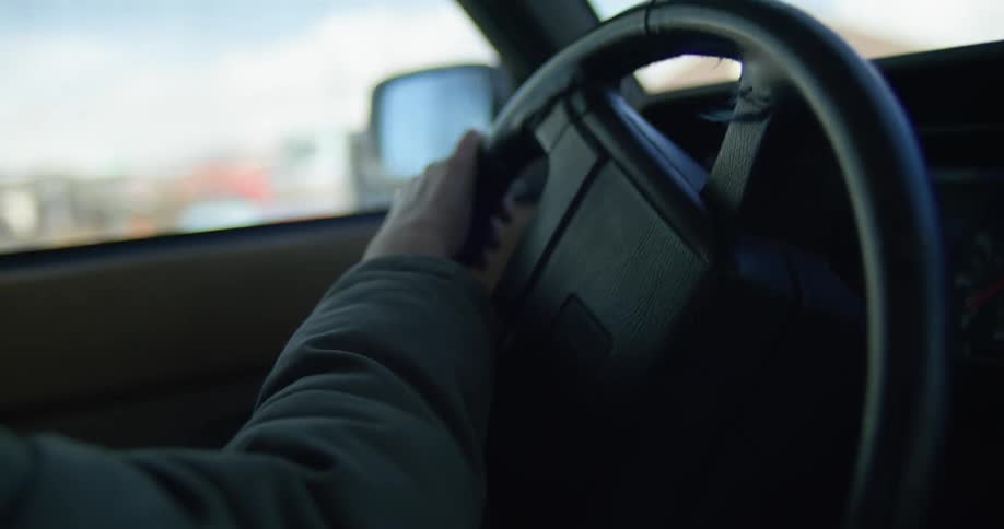 A woman making a left turn while driving a car