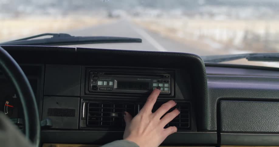 A person is driving a car in a rural area