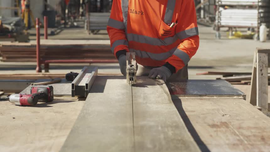 A man cutting wood on a table saw