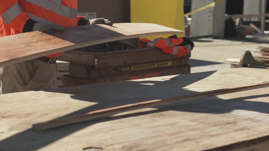 A man moving wood at a workshop