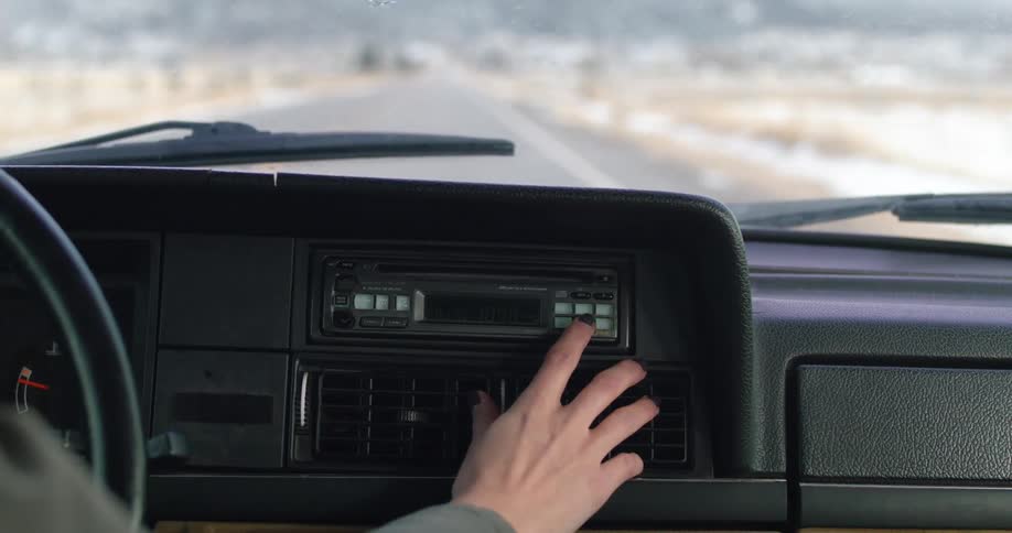 A person is driving a car on a road in spring