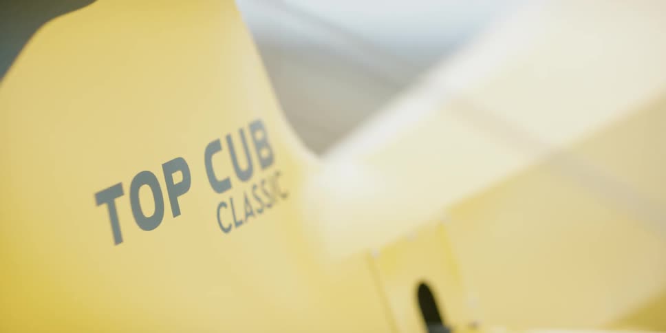 A yellow object with top cub classic written on it
