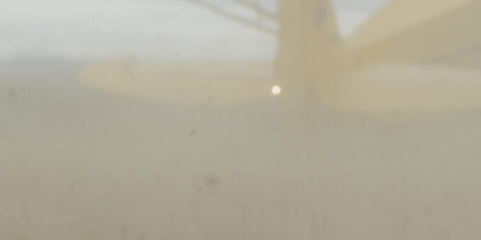 An area before a plane is covered with dust