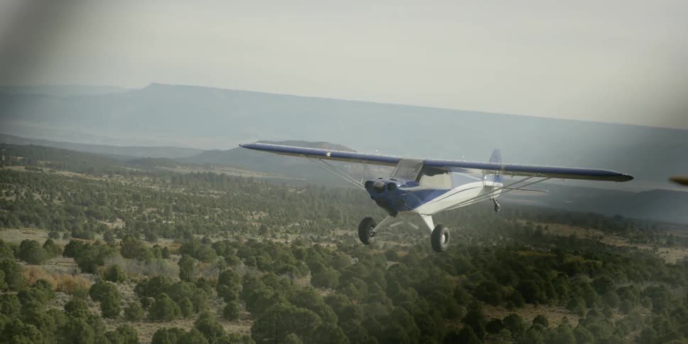 Small blue-and-white plane flying on a cloudy day