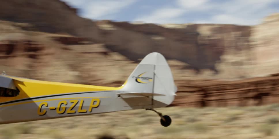 A plane lands on a desert area