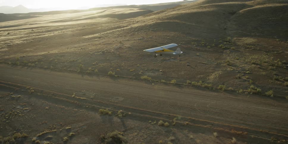 A plane flies over a runway