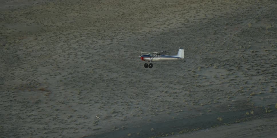 A plane flies over a deserted area