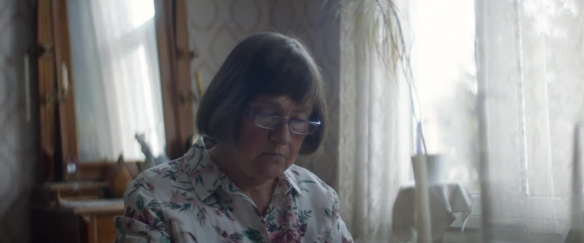Woman sitting on a table in the living room at home