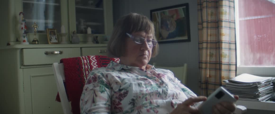 A woman reading on a smartphone
