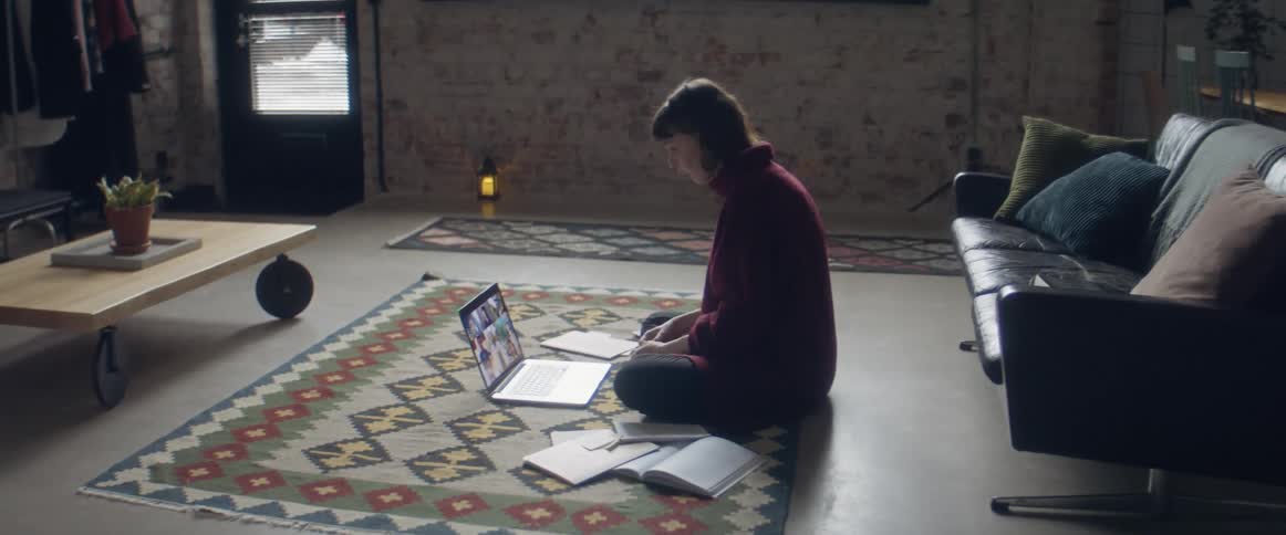 A woman talking on a laptop