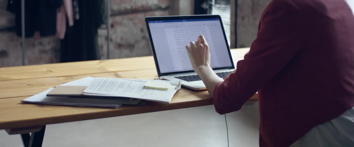 A woman typing on a computer in an office