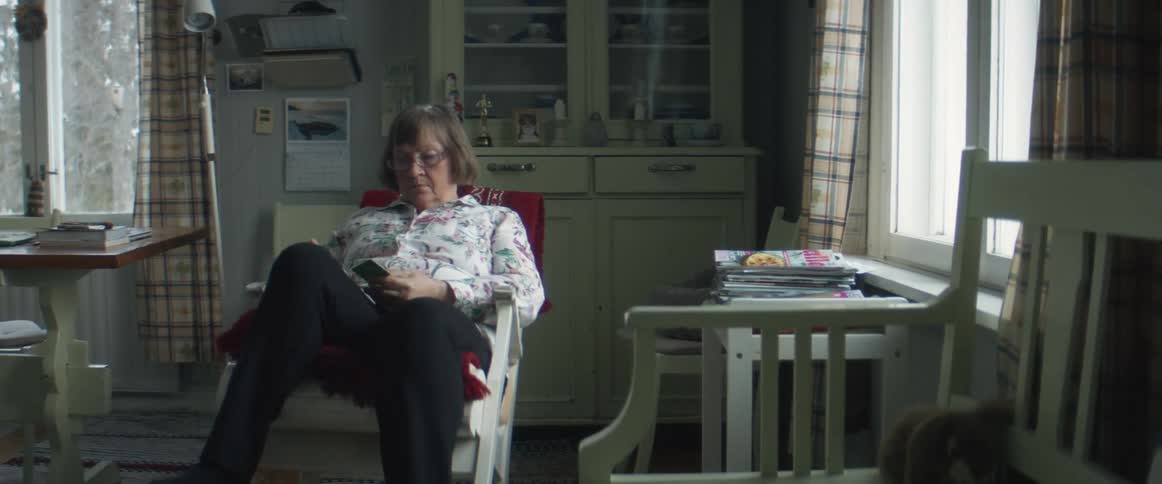 A woman that is sitting in a chair reading