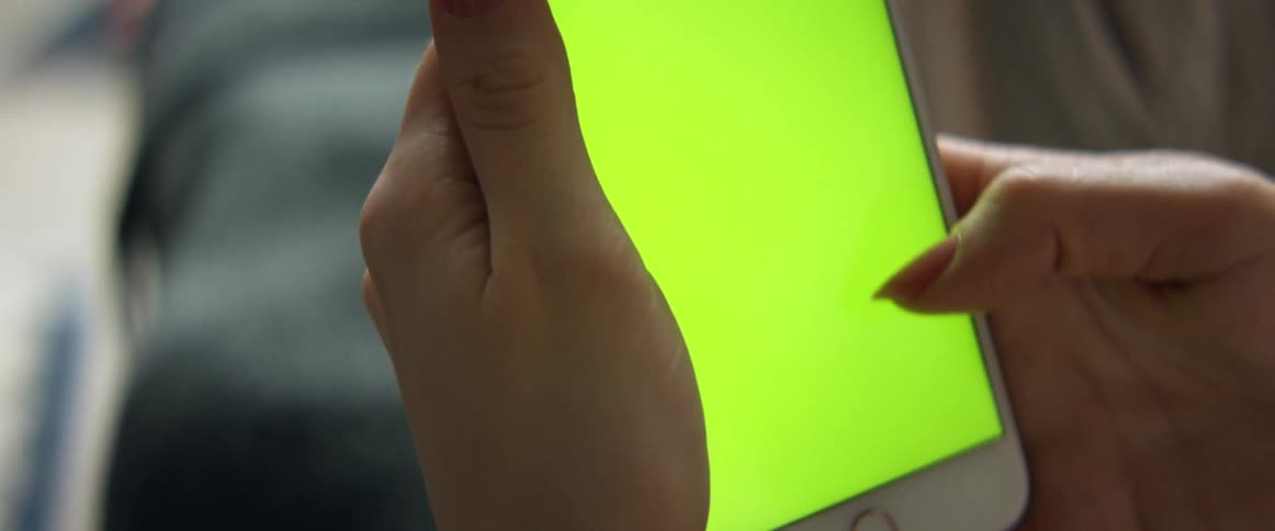 A woman uses her thumb to scroll through information that is displayed on her smart phone screen