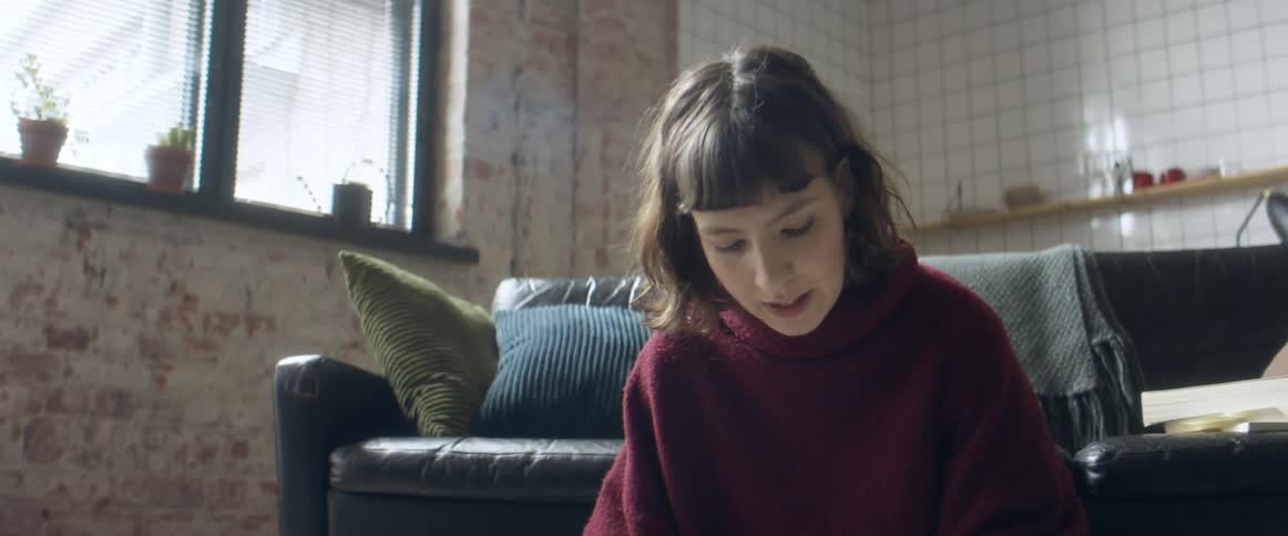 A woman sitting around talking and reading