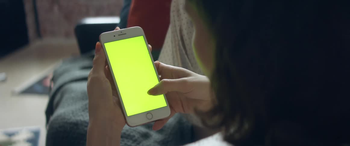A woman looking at things on a smartphone