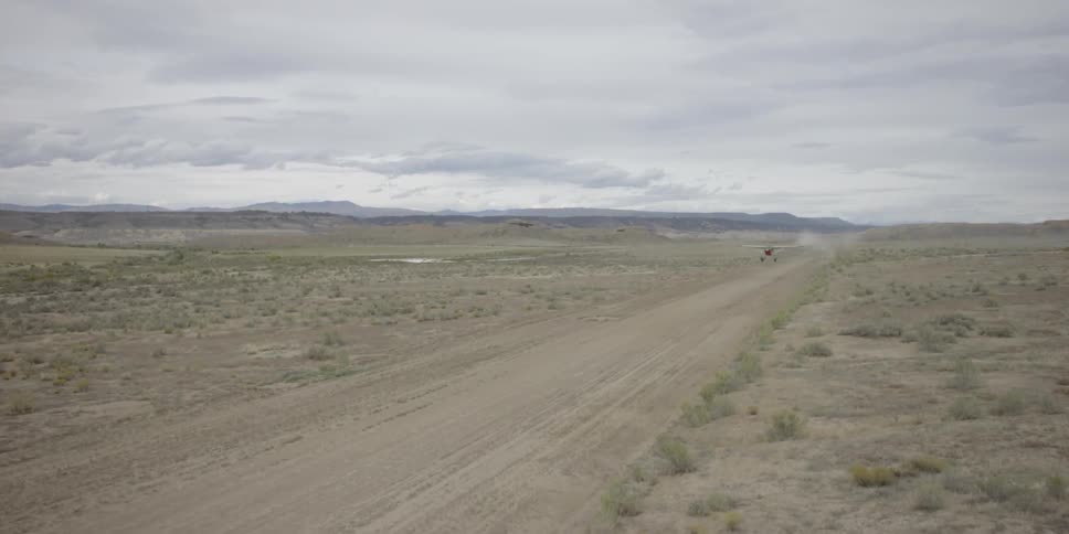 A plane takes off in a desert