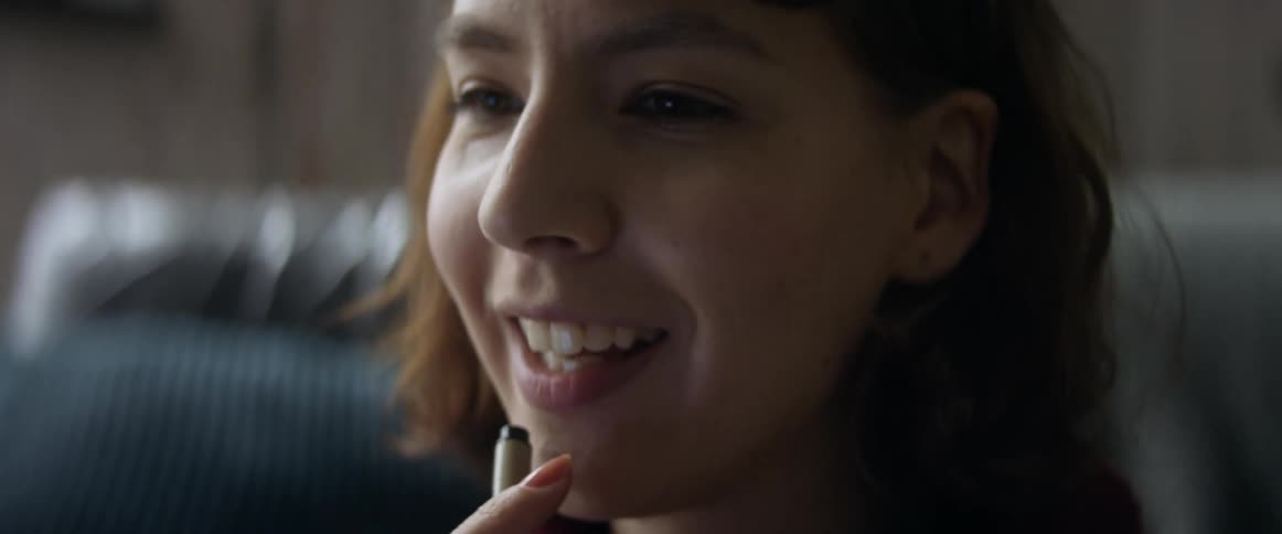 Happy woman smiling while talking to friends
