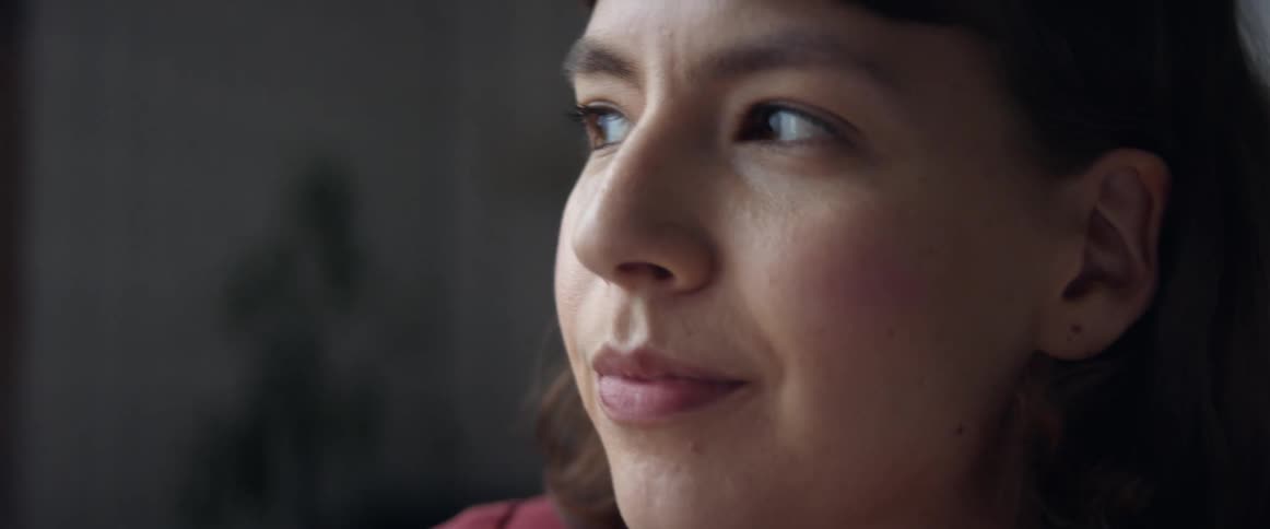 Close up of a teenage girl smiling and thinking