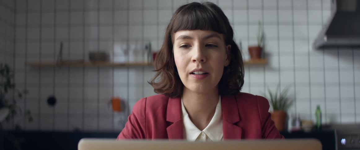 A woman talking to a laptop
