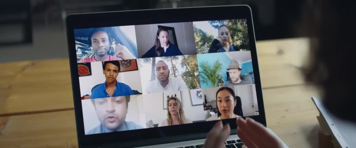 A group of friends having a meeting through a video call on a laptop