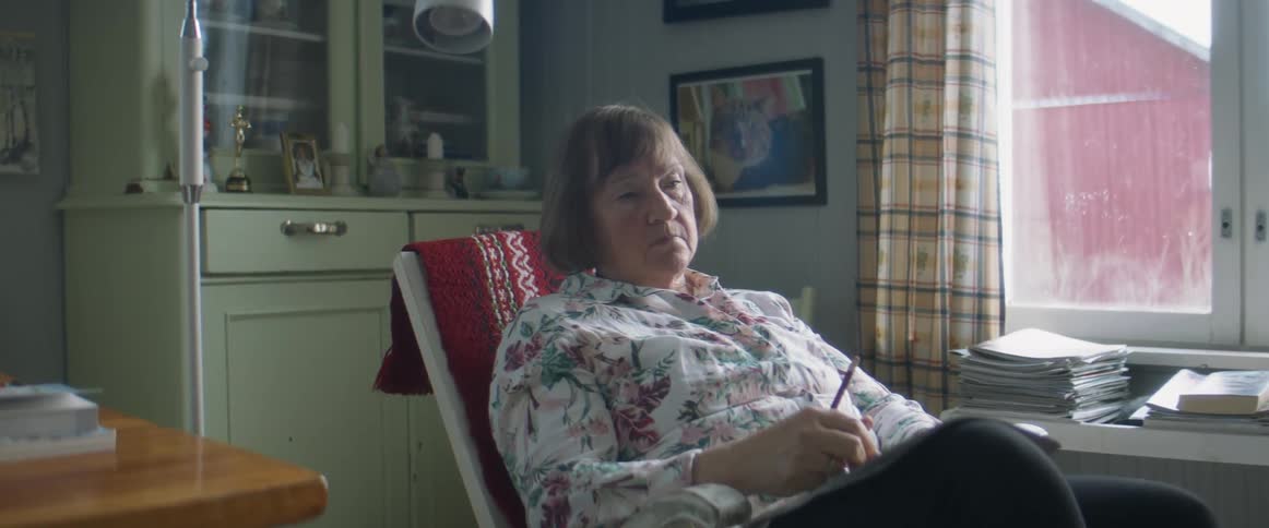A woman sitting in a room sad
