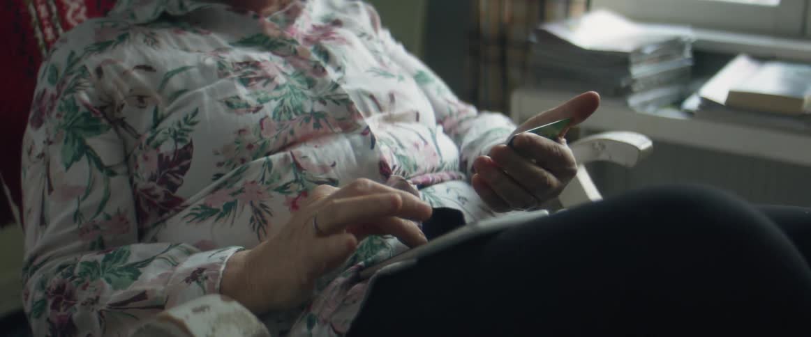 A woman typing on a smartphone