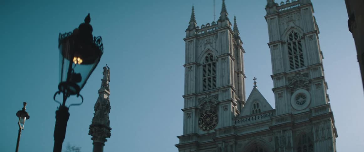 The top of a clock tower viewed from ground level outdoors at daytime
