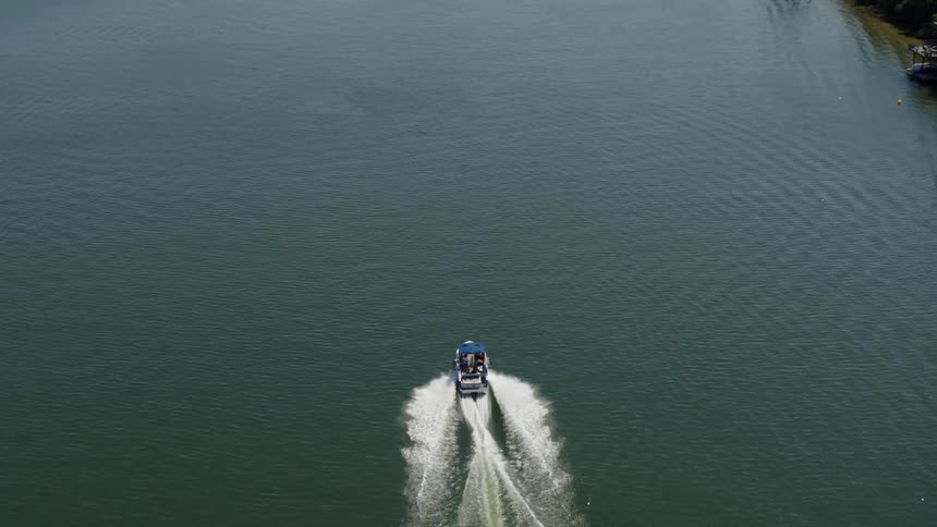 An aerial view of people boating on a lake