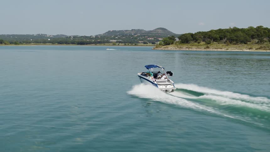 Motor boat driving on the calm waters of a lake at daytime