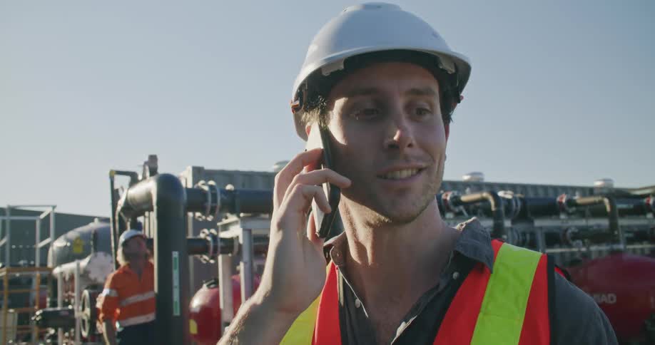 An employee at a construction site talking on the phone
