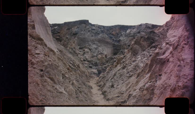 A narrow canyon between dirt mounds caught on analog Film 16mm