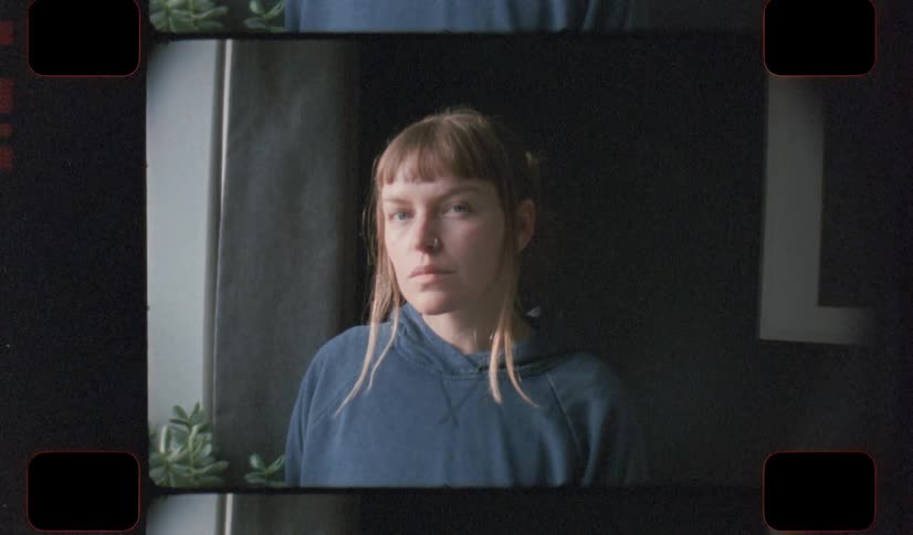 A portrait of a woman looking outside during covid 19 pandemic on analog Film 16mm