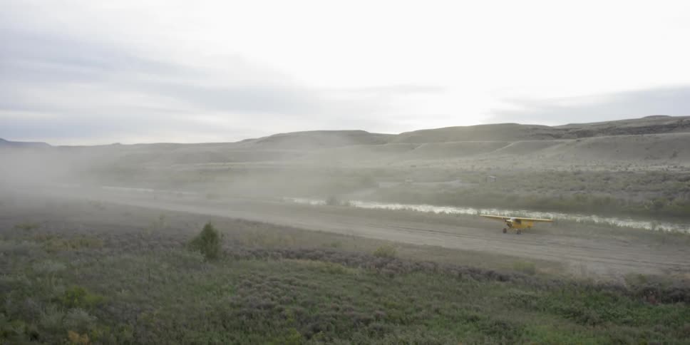A small airplane is parked in the wilderness