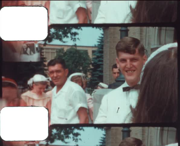 A vintage film of a bride and groom greeting people