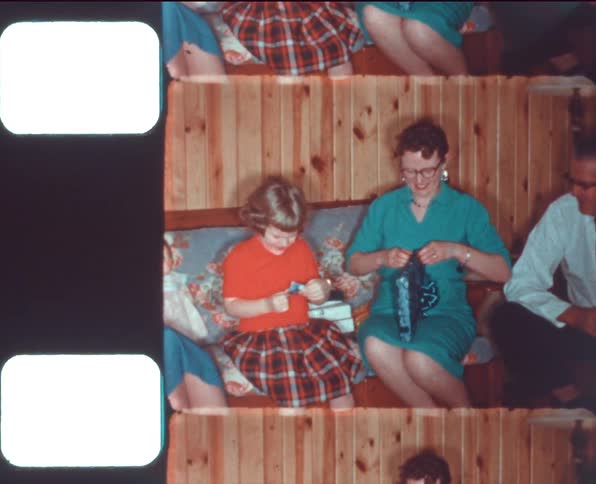 Family opening christmas presents caught on vintage film