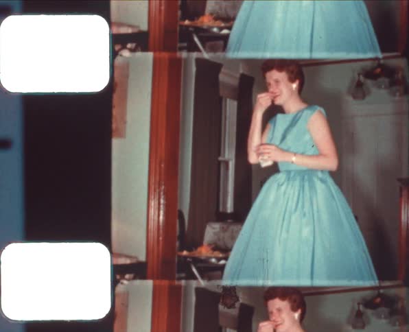 A woman in a dress picking up food