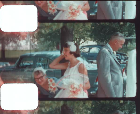 Maids and family waiting for a wedding to begin caught on vintage film