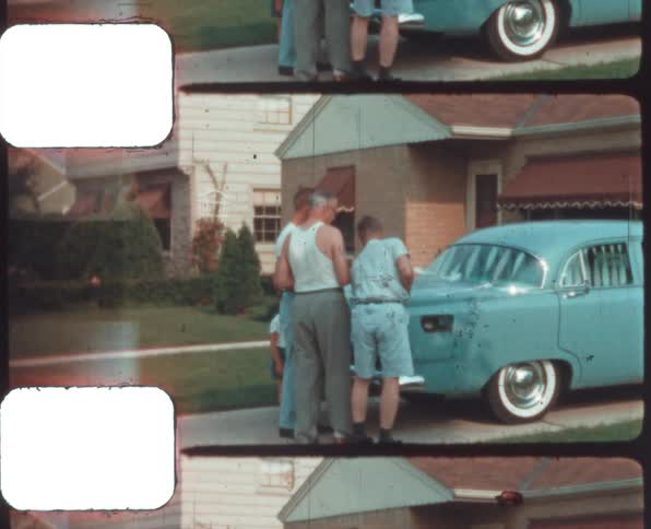 Three men and a boy looking at a automobile