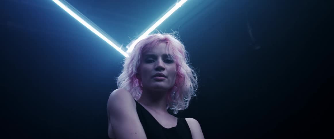 A portrait of a woman standing in a room