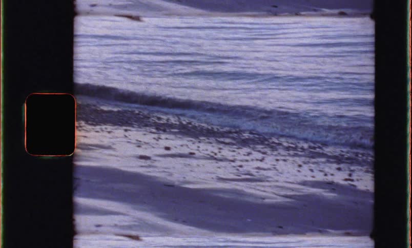 A view of waves on the beach at dusk
