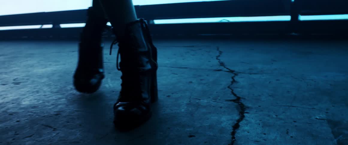 A close up of a womans feet in heels in a club