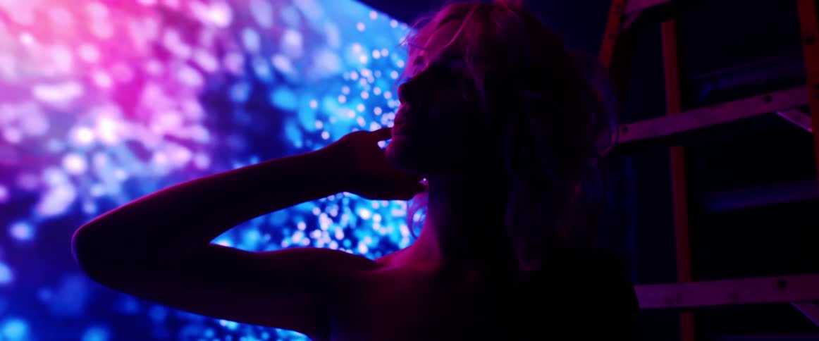 A model poses in front of bright lights